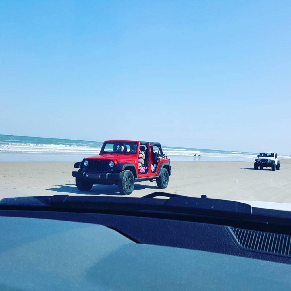 Red jeep on Ocean Shores beach
