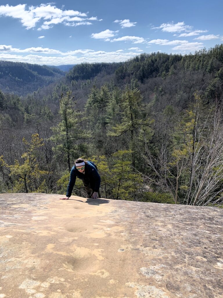 Image of Casey (the author) climbing up the Indian Staircase Trail rockface